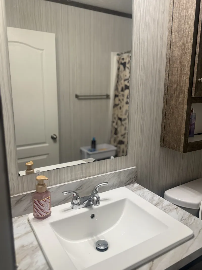 Bathroom with cleaned tub, toilet and vanity